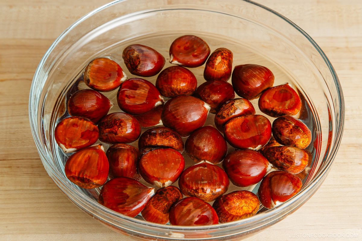 Chestnut being soaked in a large bowl of warm water.