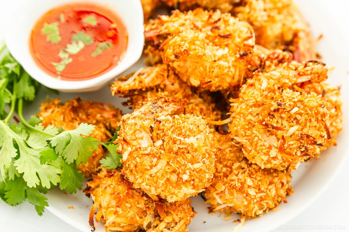 Coconut shrimp with sauce on a white plate.