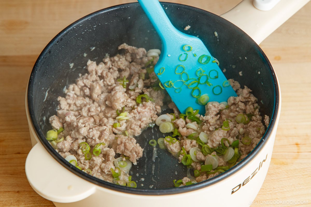 Saute the meat with aromatics.