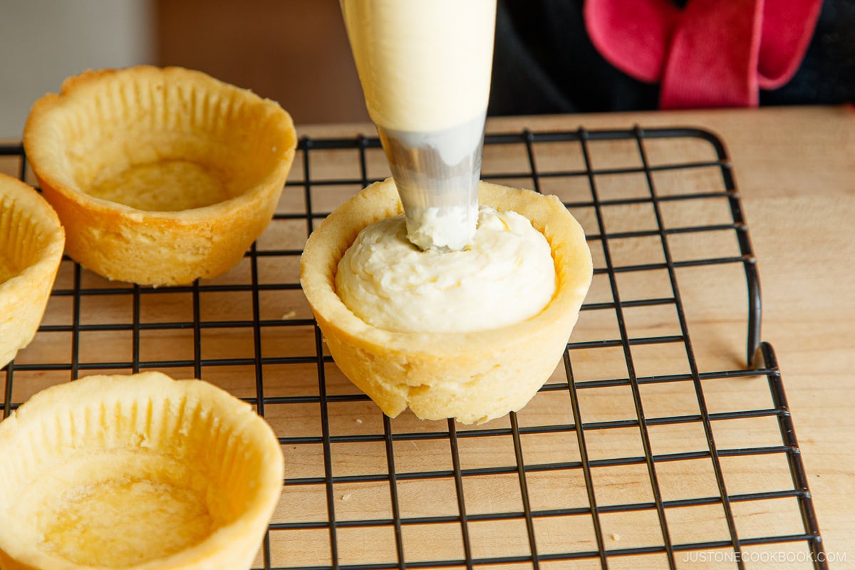 Filling up the pastry with cheese filling.