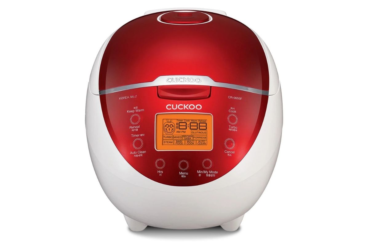 Red and white Cuckoo rice cooker with digital display and multiple cooking functions, ideal for Asian cuisine and rice dishes.