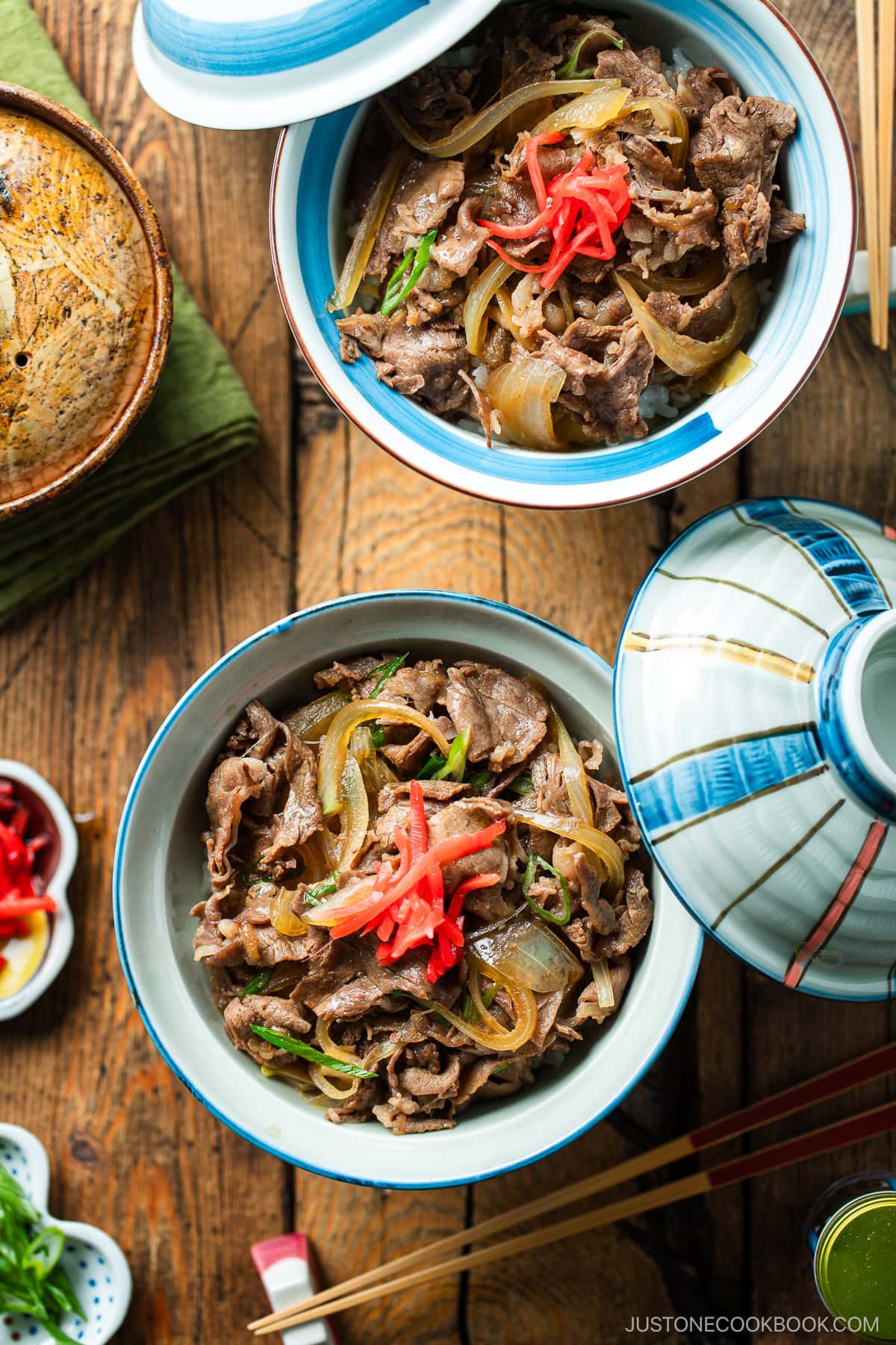 Donburi rice bowls containing gyudon, simmered beef and onions over steamed rice.