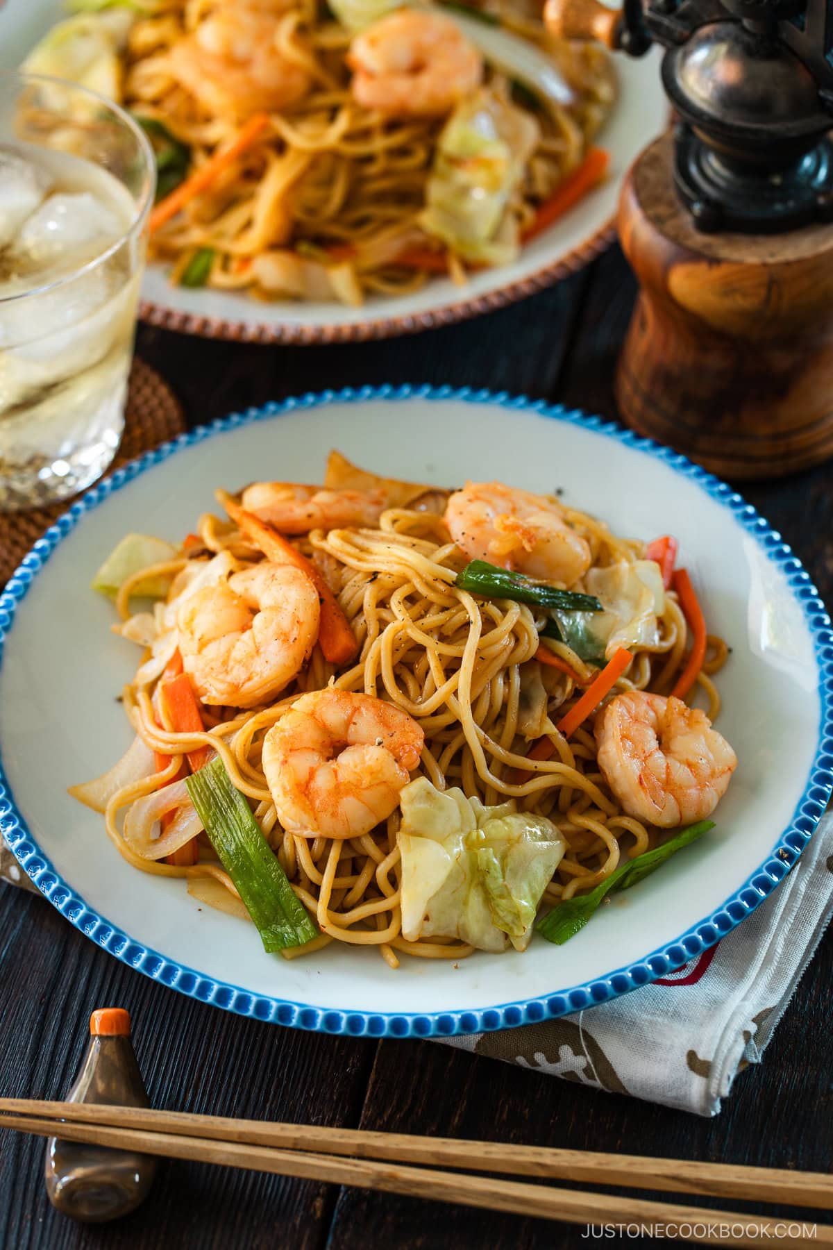 Round plates containing shrimp yakisoba.