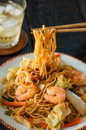 Round plates containing shrimp yakisoba.
