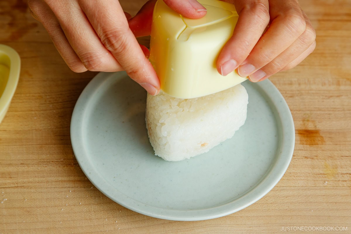 Push to unmold the onigiri.