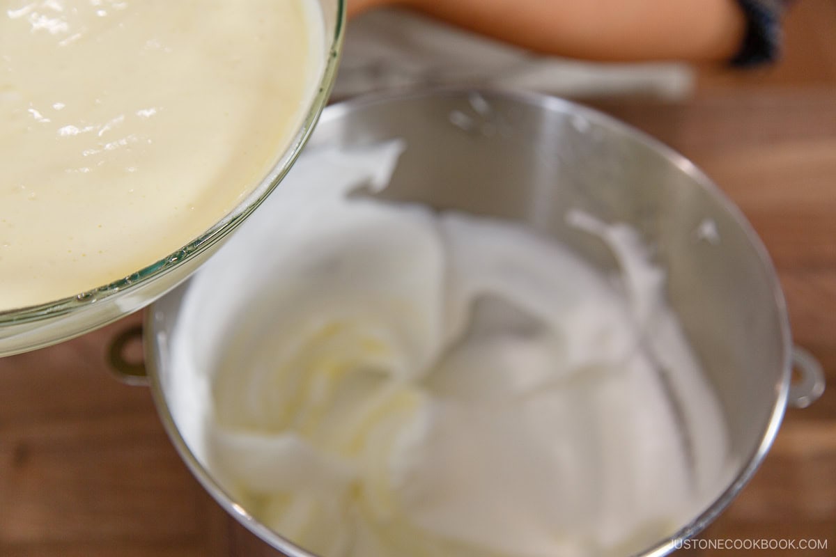 Pouring the cake batter into the egg whites.