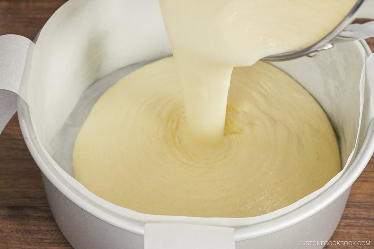 Pouring the batter into the cake pan.