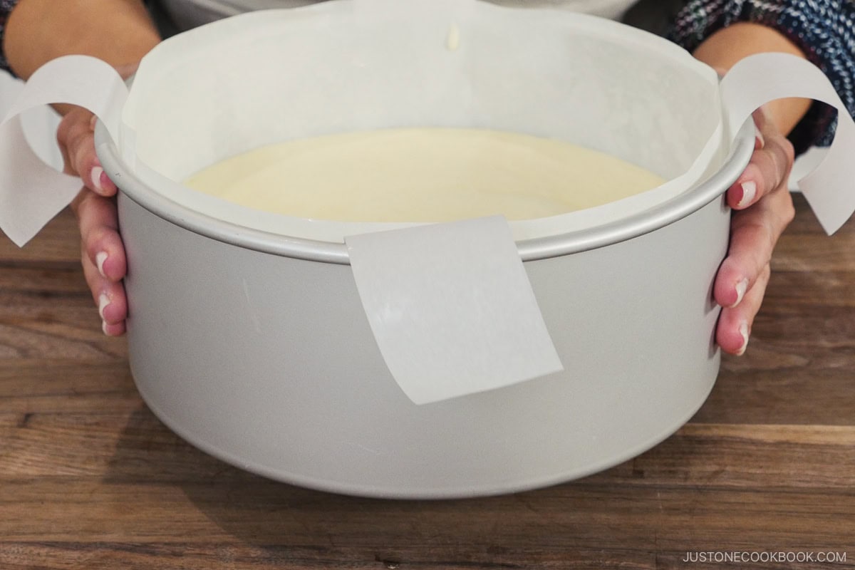Tapping the cake pan on the counter top