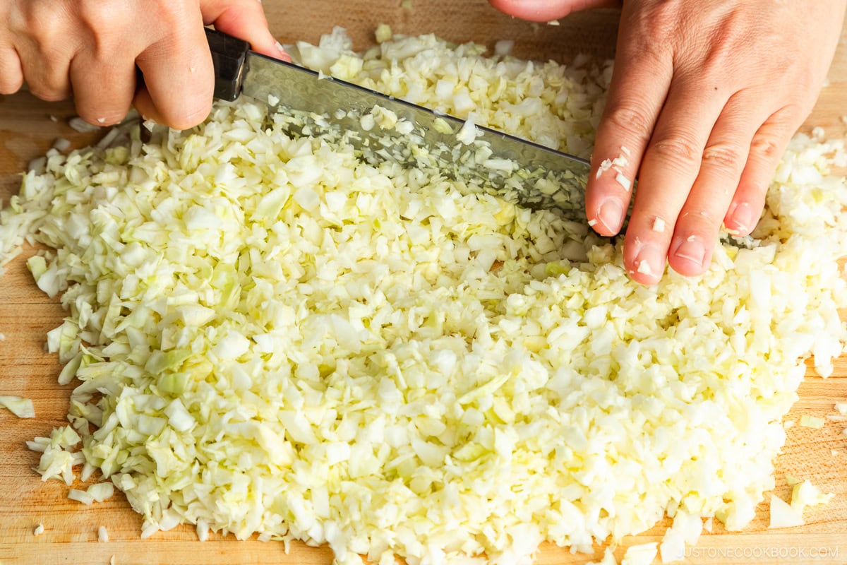 Chopping cabbage leaves.