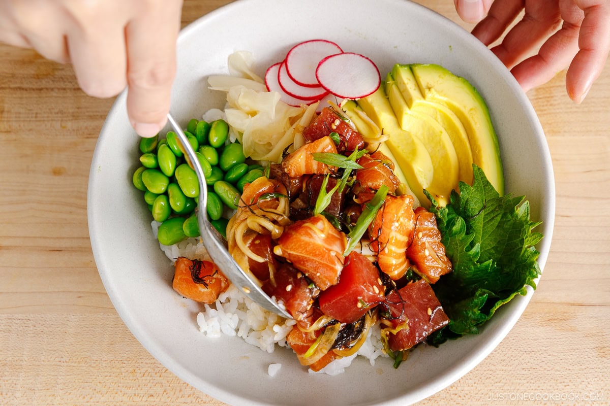Serve the salmon and tuna poke over the rice.