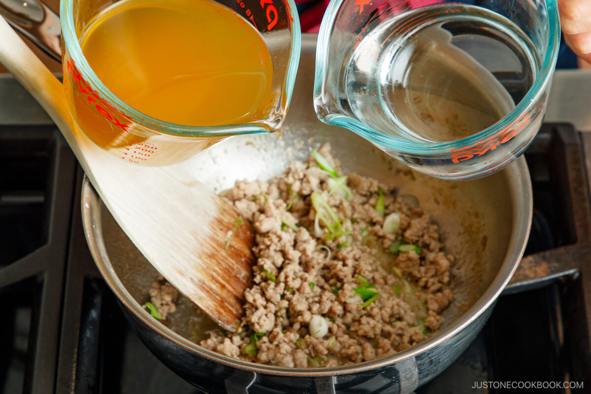 Adding the chicken stock and water.