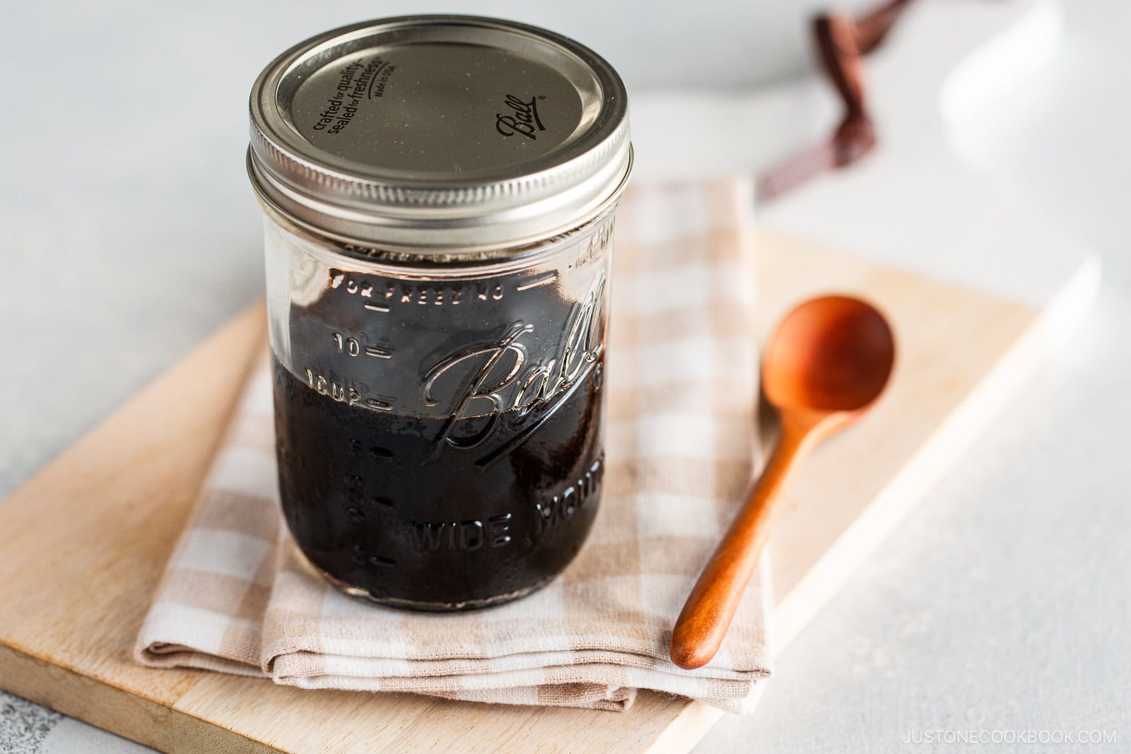 A glass mason jar containing homemade teriyaki sauce.