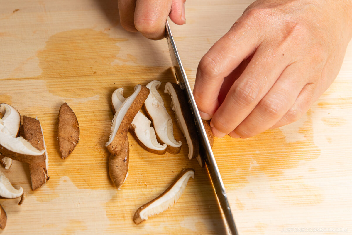 Slicing shiitake mushrooms.