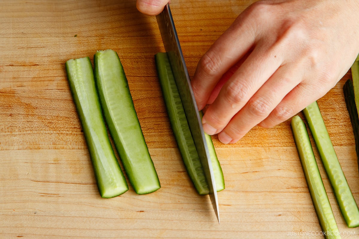 Remove seeds from cucumber and cut into thin strips.
