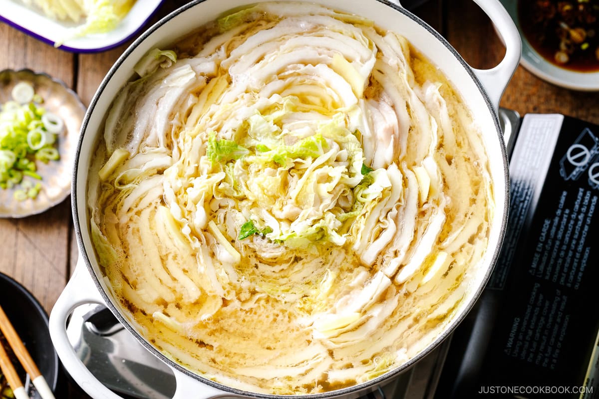 Cover the lid and bring to a boil. Then, reduce to medium-high heat and simmer until the cabbage is tender and the pork is fully cooked. 