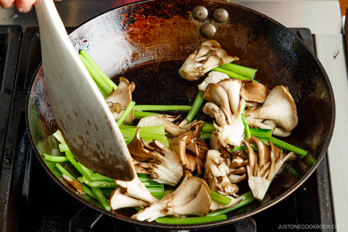 Stir fry the green and mushrooms.