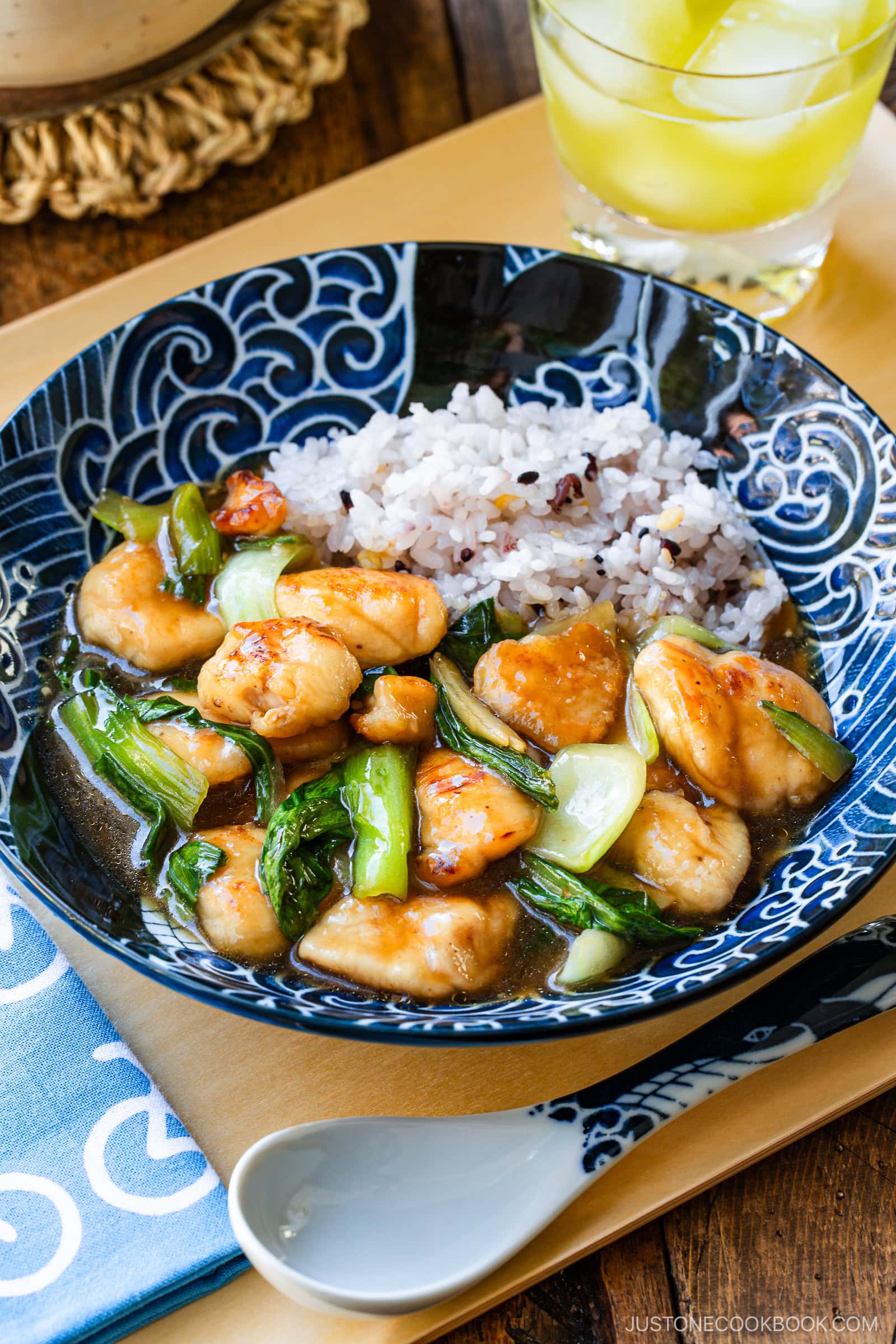 A large shallow bowl containing multi-grain rice and Chicken Bok Choy Stir Fry.