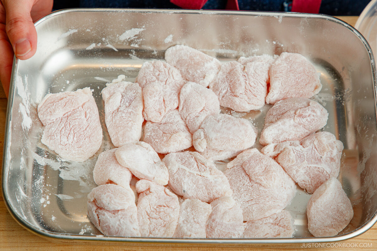 Coat the chicken with potato starch in a stainless steel prep tray from JOC Goods.