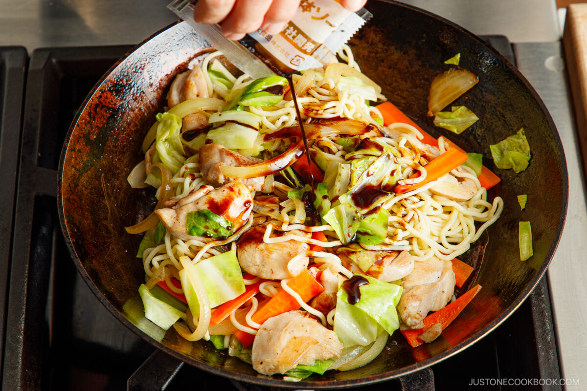 Add the yakisoba sauce to the noodles.