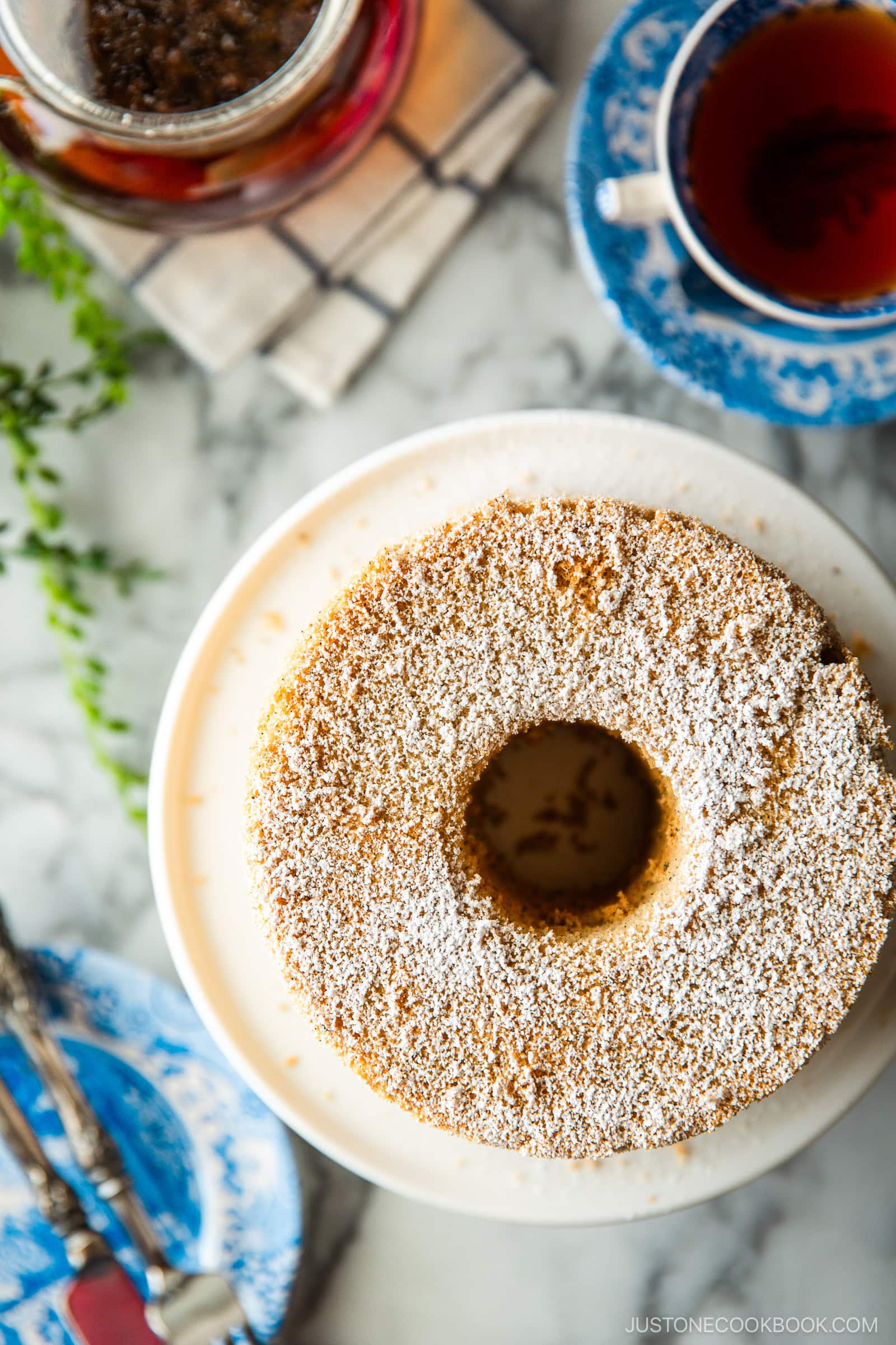 A plate containing Earl Grey Chiffon Cake dusted with powdered sugar on top.