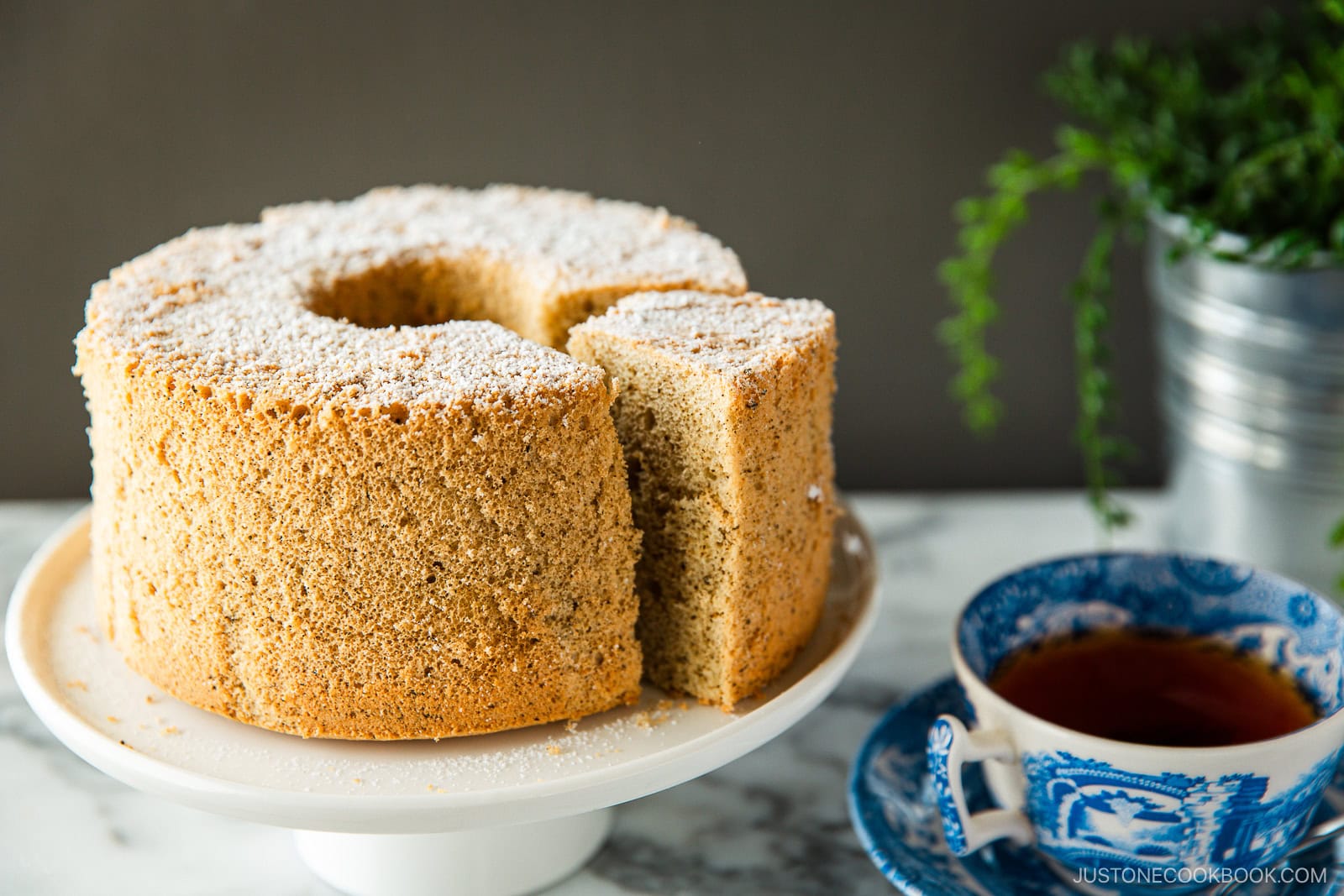 A plate containing Earl Grey Chiffon Cake dusted with powdered sugar on top.