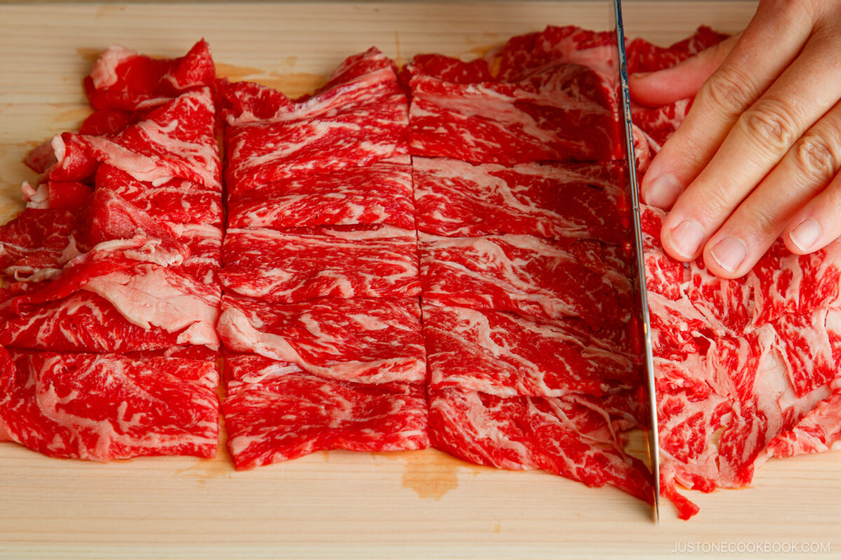 Cut the thinly sliced beef into smaller pieces.