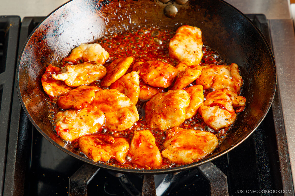 Cooking the chicken in honey gochujang sauce.