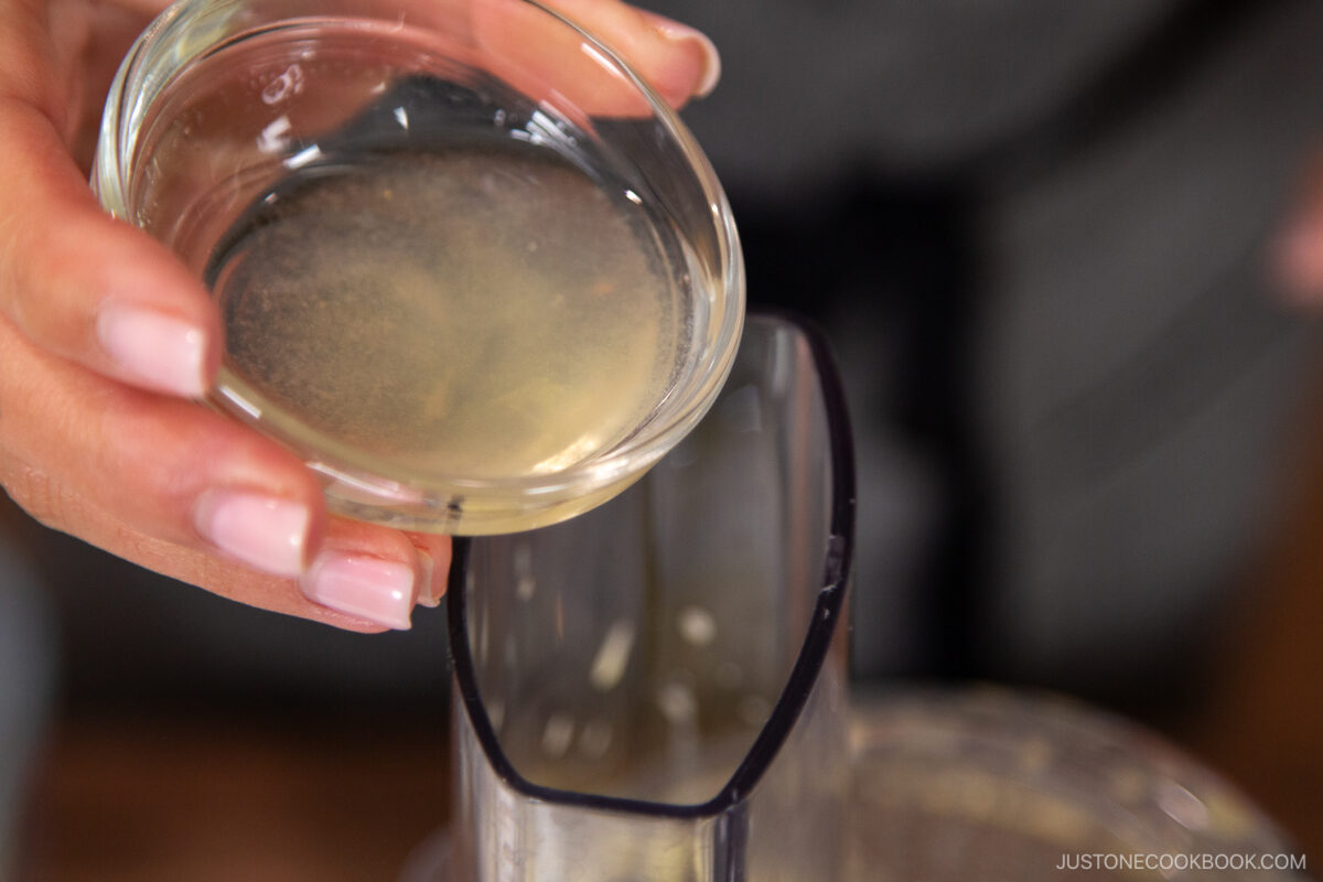 Add the rice vinegar, lemon juice, and remaining oil. Process for an extra 10 seconds, just until the ingredients are combined and emulsified.