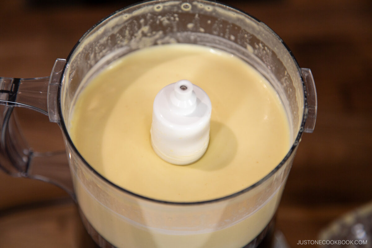 Add the rice vinegar, lemon juice, and remaining oil. Process for an extra 10 seconds, just until the ingredients are combined and emulsified.