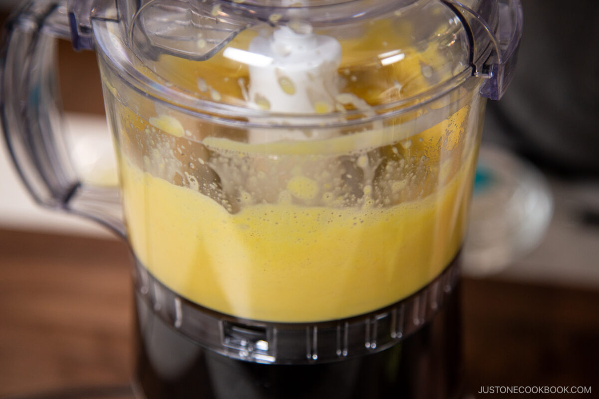 Add egg yolks and the Dijon mustard to the bowl of a small food processor or blender and process for 20 seconds.
