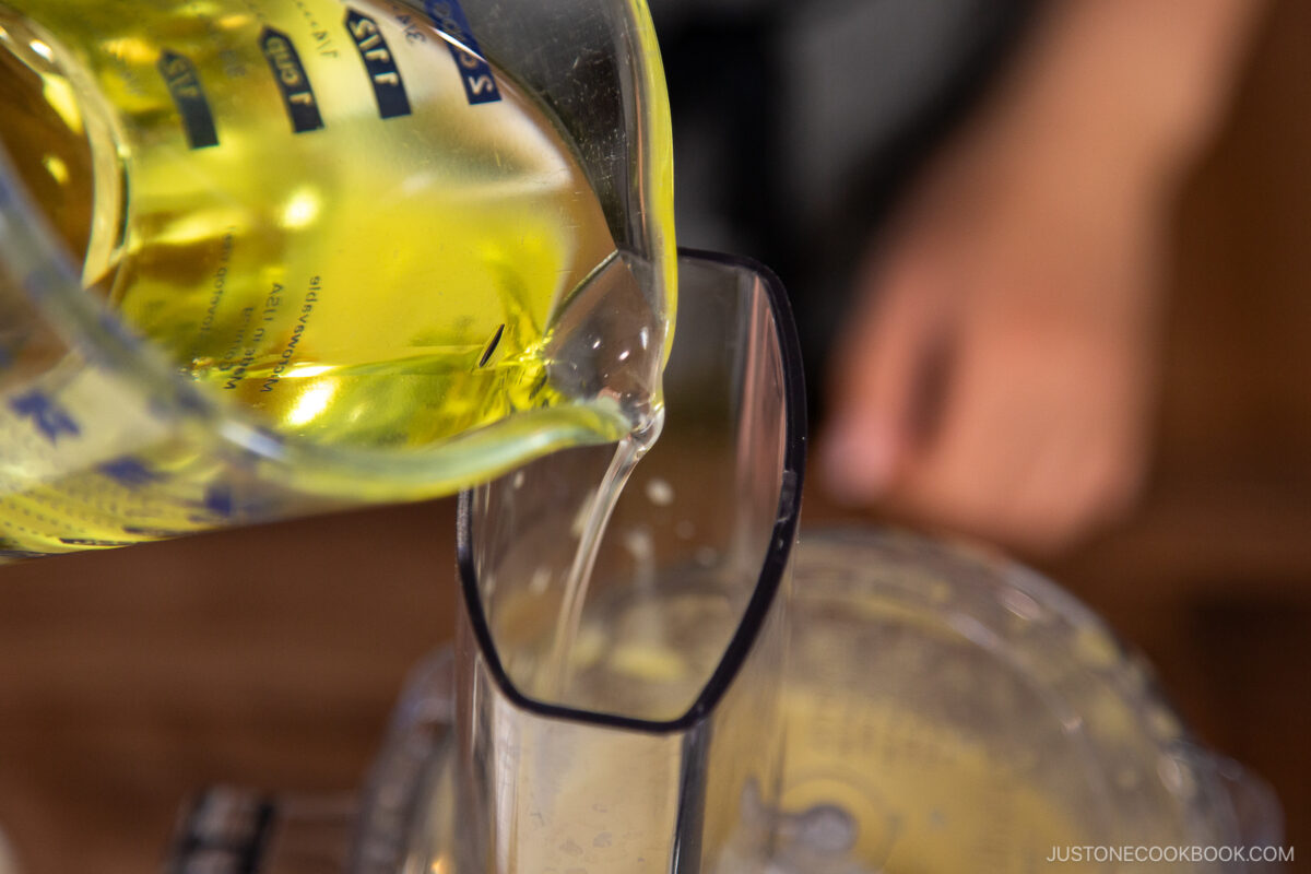 Drizzle in another one-third of the oil in a thin, steady stream.