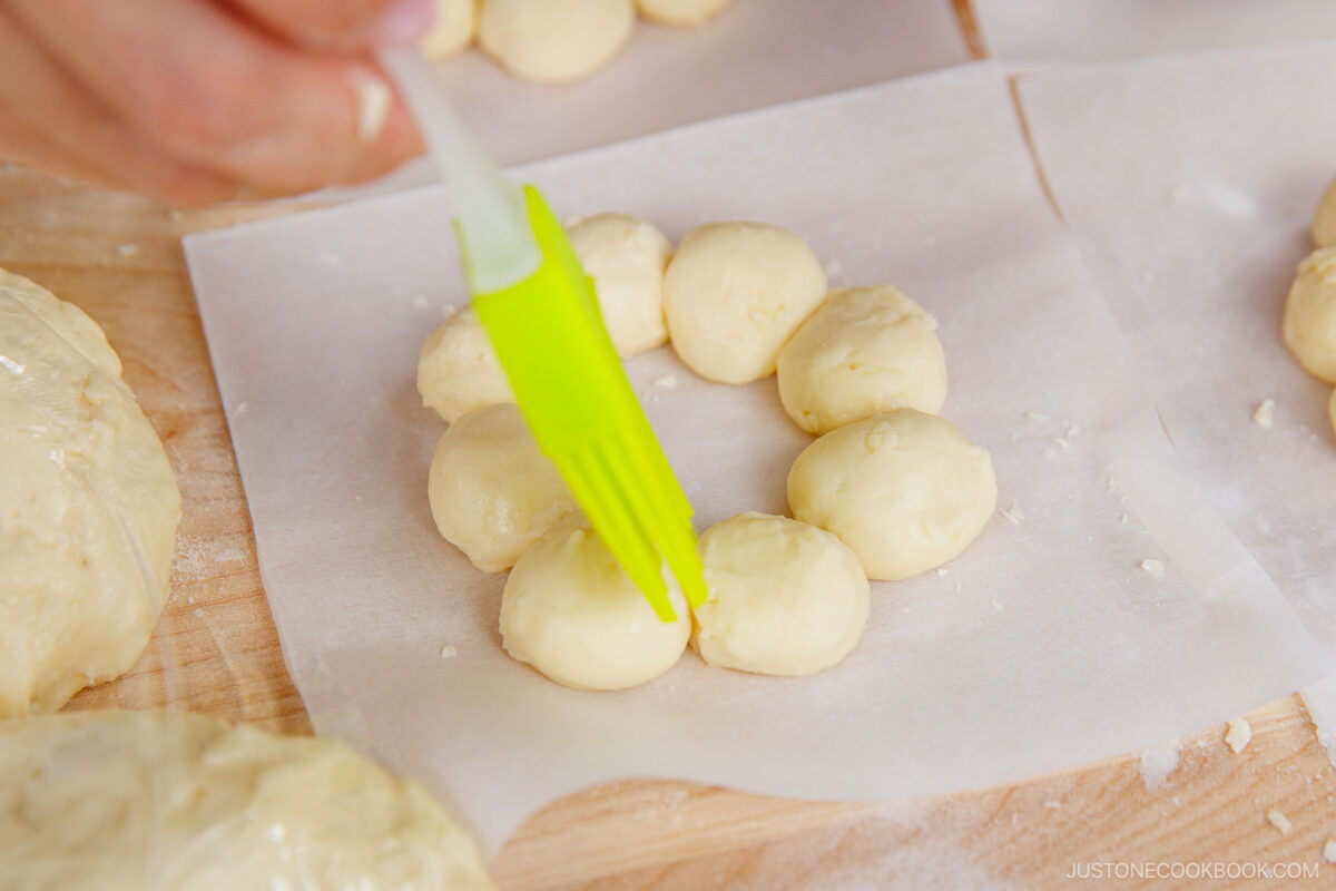 Dabbing water to connect the balls.