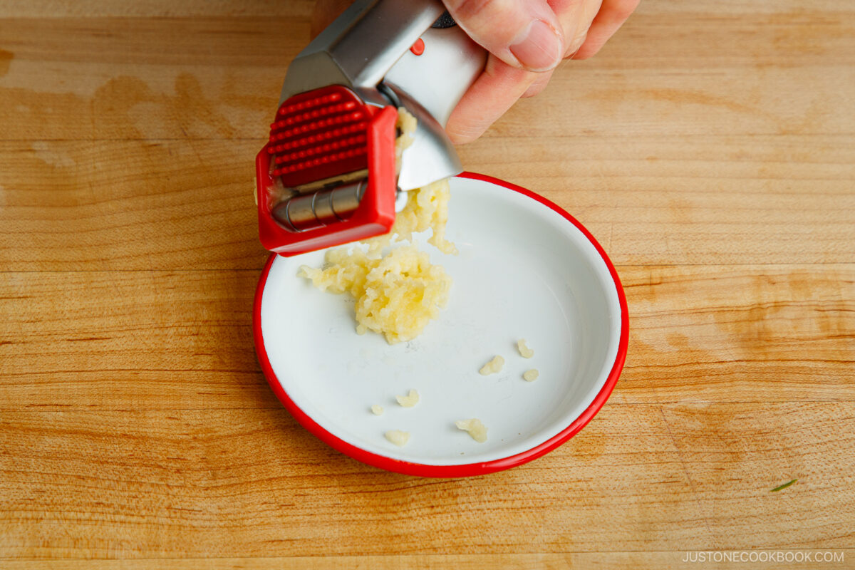 Crush the garlic cloves.