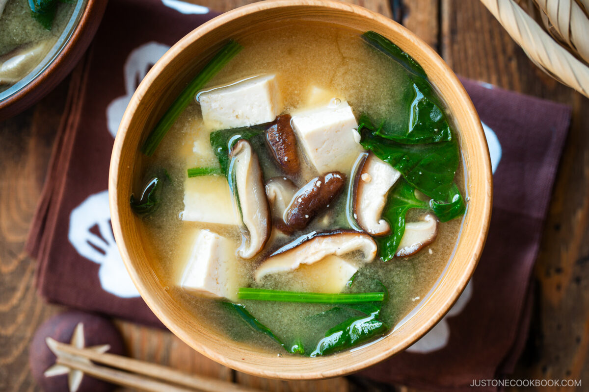 Wooden soup bowls containing Spinach and Mushroom Miso Soup.