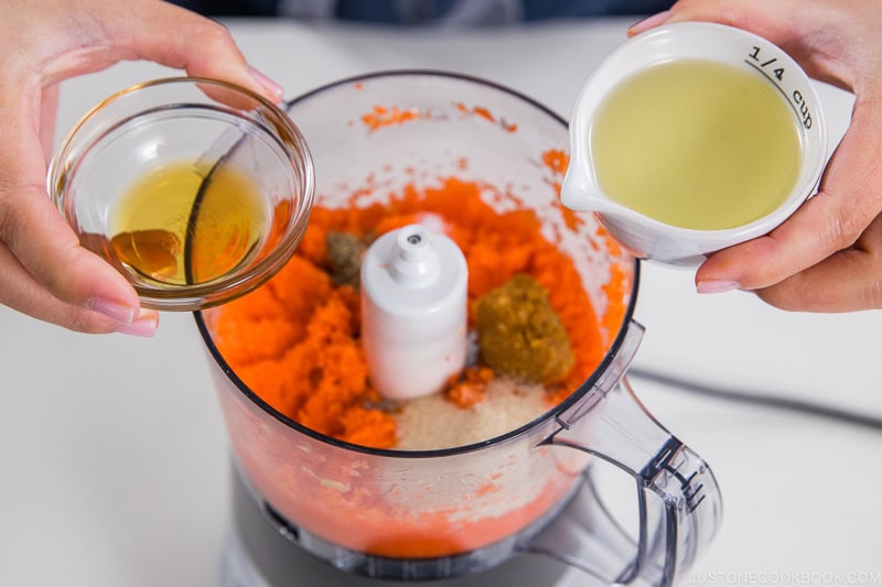 Adding seasonings to chopped ingredients in the food processor.