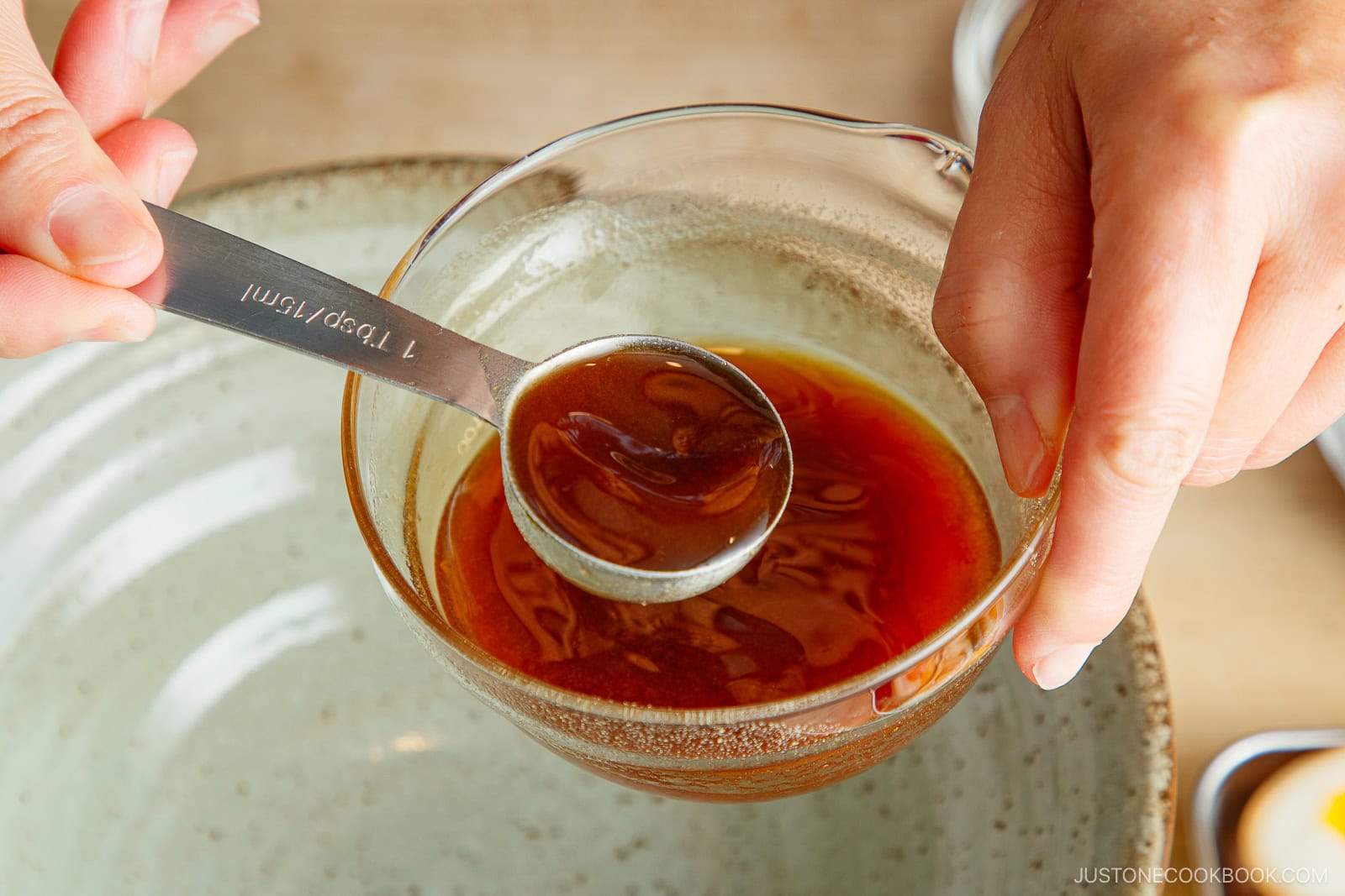 Add the shoyu tare to the ramen bowl.