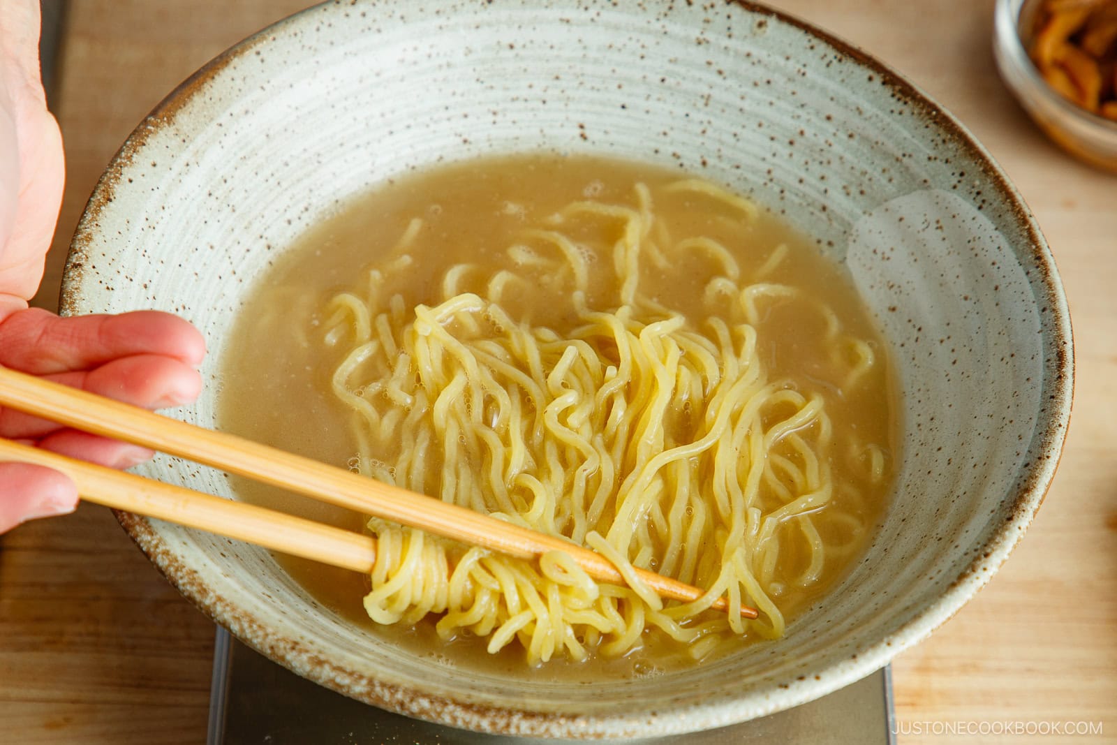 Adding the noodles to the bowl.