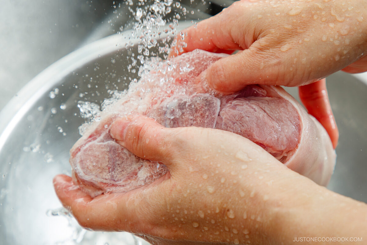 Rinsing a pork bone.