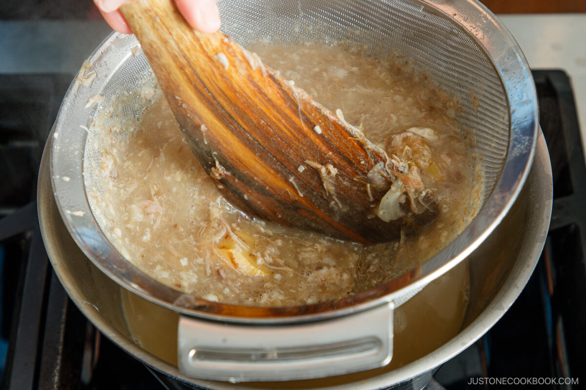 Straining the solids.