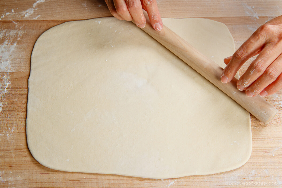 Flatten the dough with your hand on a work surface dusted with potato starch. Roll it out into a rectangle. It should be ⅛ inch (3 mm) thick and 10–12 inches long.
