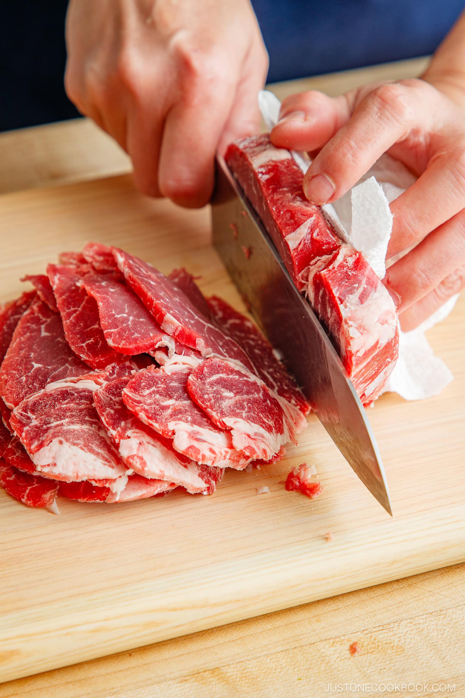 Slicing the block of the ribeye and filet mignon thinly.
