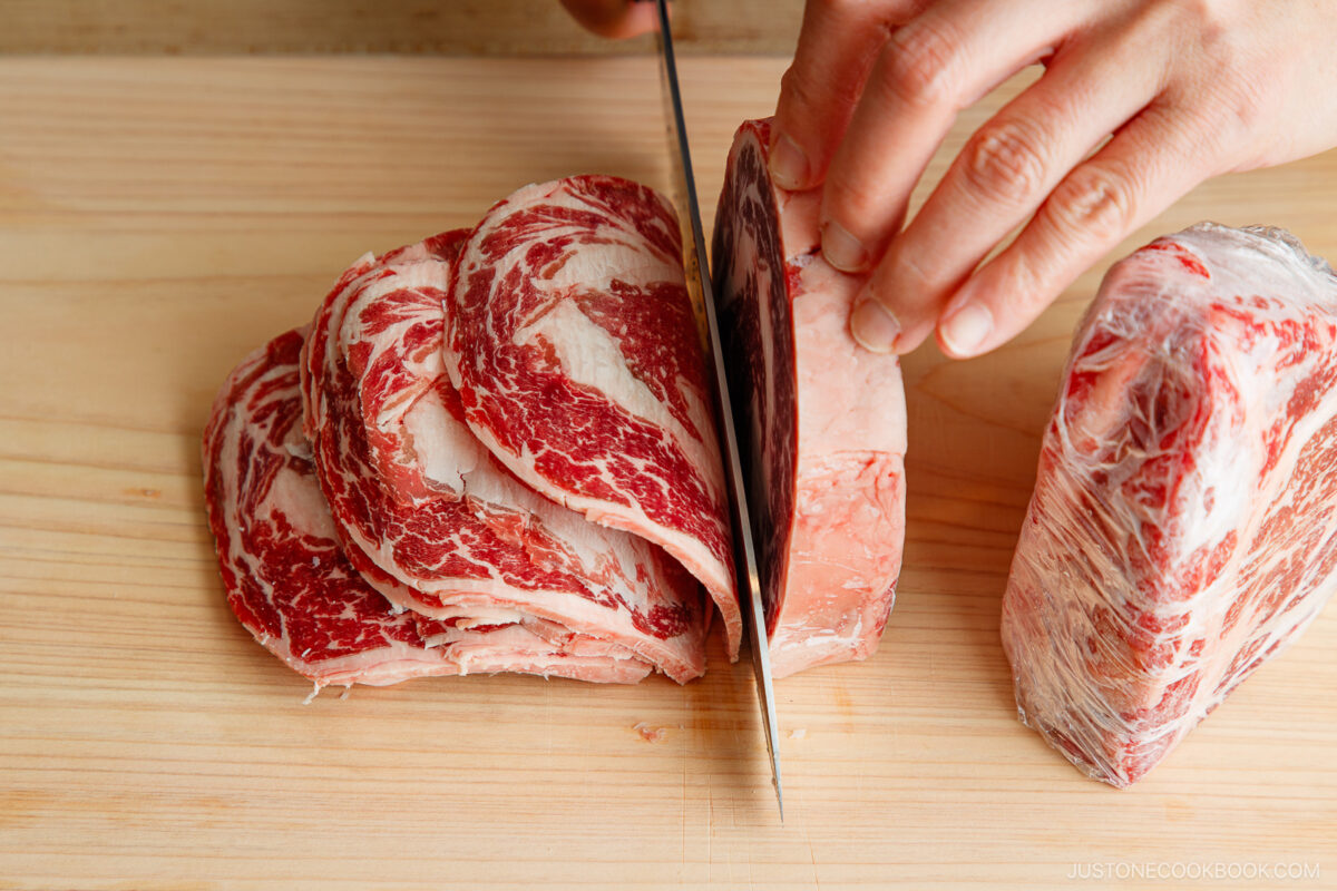 Slice the frozen meat thinly.