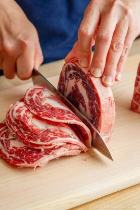 Slicing the block of the ribeye and filet mignon thinly.