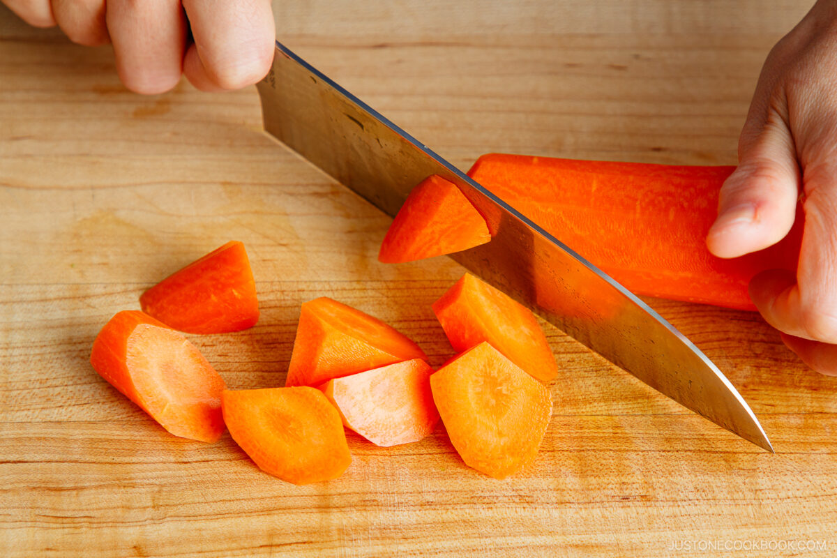 Cutting carrot in rangiri Japanese cutting technique.