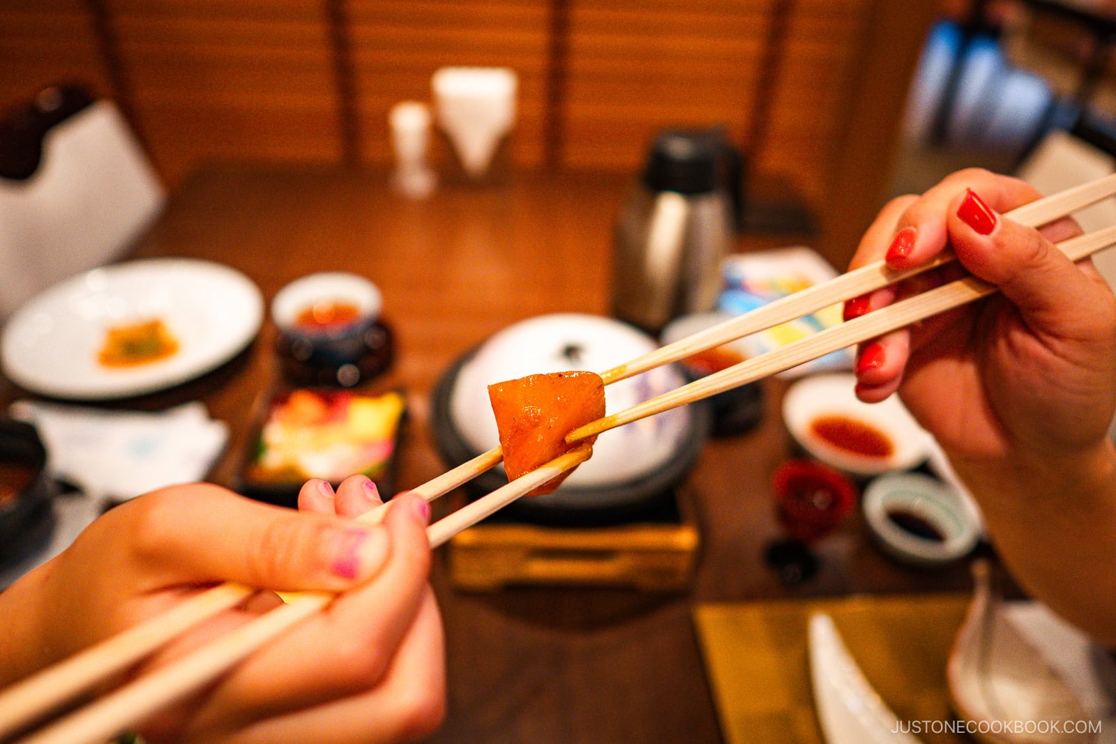 Passing food with chopsticks to chopsticks.