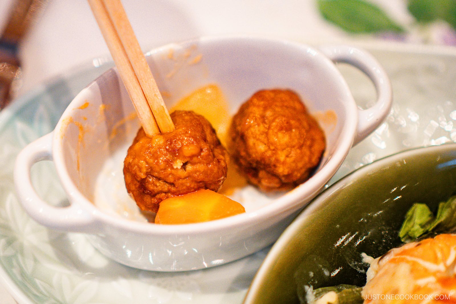 Poking food with chopsticks.