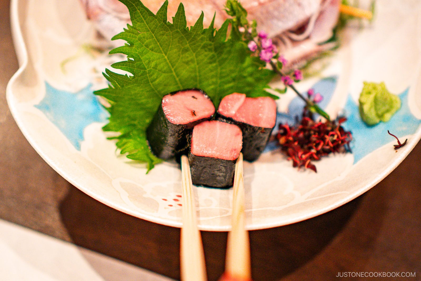 Picking up a food on a communal plate with your own chopsticks.