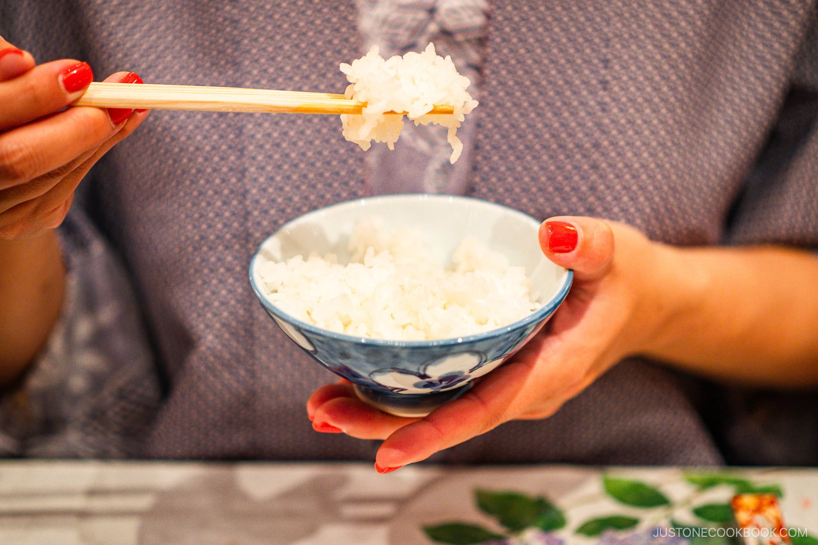 Picking up a rice bowl.