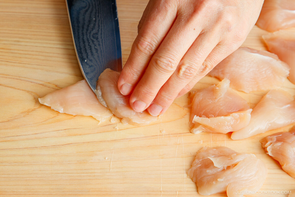 Slicing the chicken with a knife.