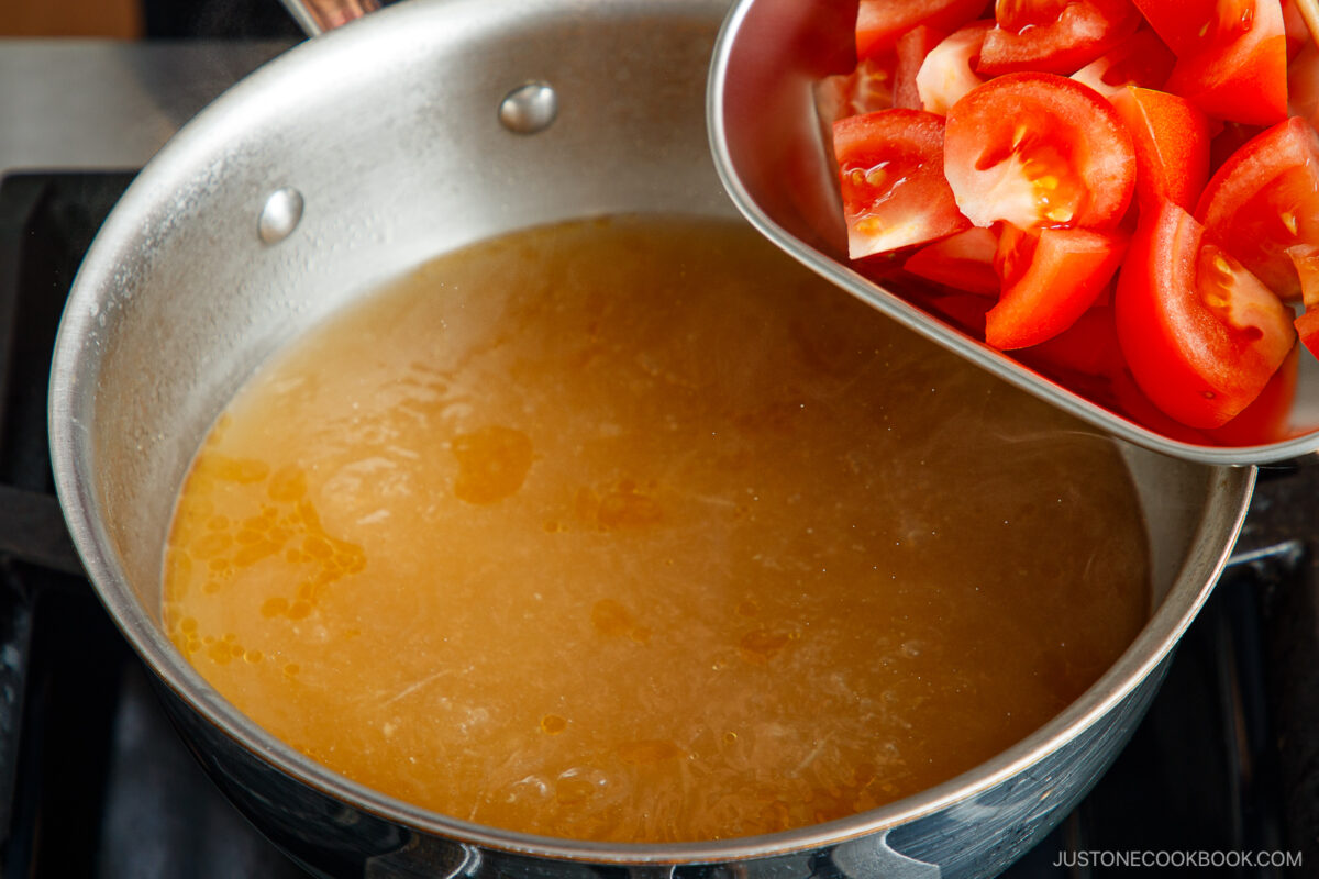 Add the tomatoes to the soup.